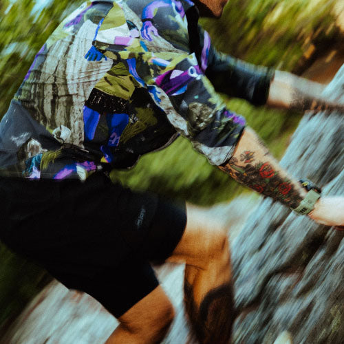 hiker running alongside a lake in fells