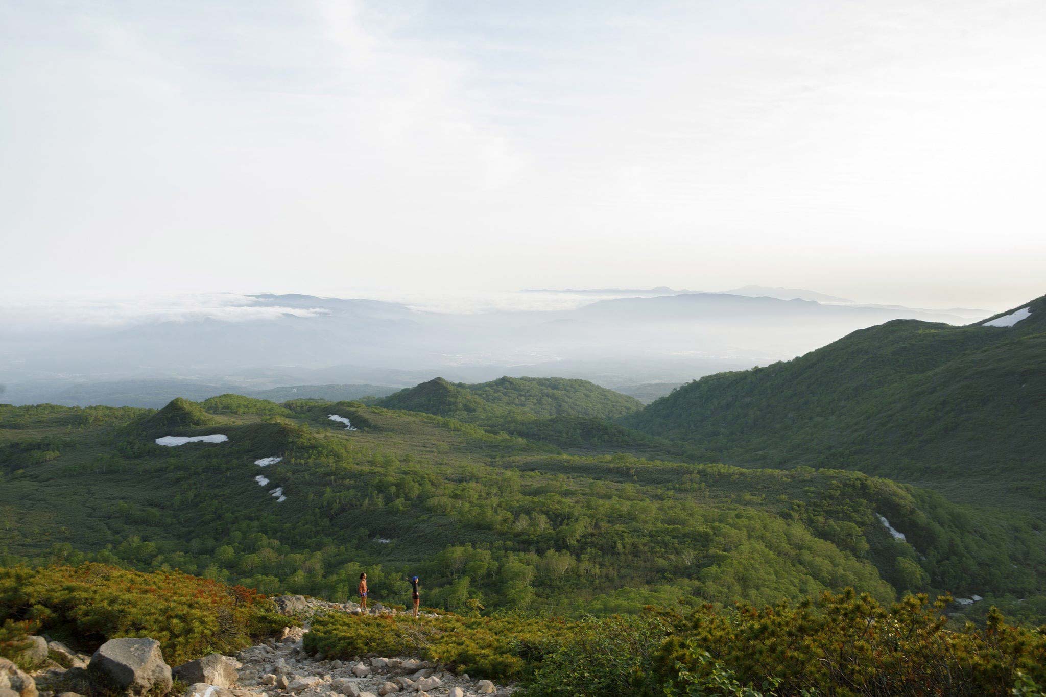 two hikers standing on overlook