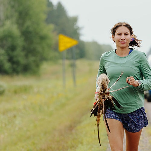 woman running along road